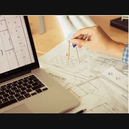 Architect reviewing plans with a drawing compass